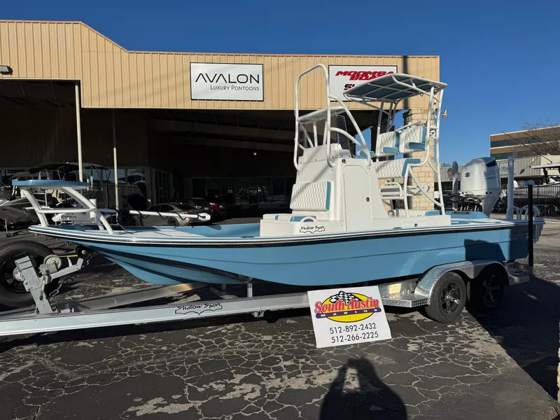 Slide: The Image of 2025 Shallow Sport 24 Sport boat on trailer outside dealership. - 37