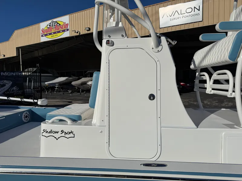 Slide: The Image of 2025 Shallow Sport 24 Sport boat at dealership, showcasing sleek design and seating. - 6