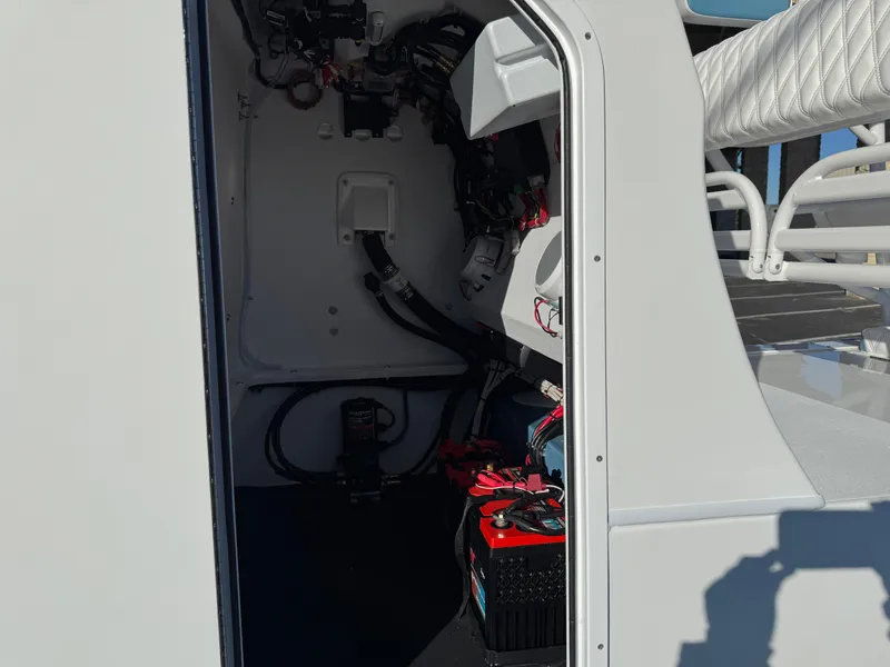 Slide: The Image of Interior view of 2025 Shallow Sport 24 Sport boat showing wiring and battery setup. - 7