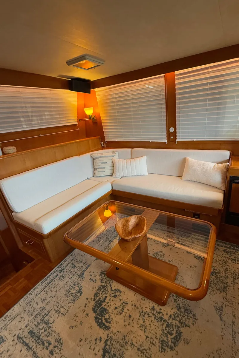 Slide: The Image of Luxurious 1988 Ocean Alexander 42 CPMY yacht interior with white seating and wooden accents. - 10
