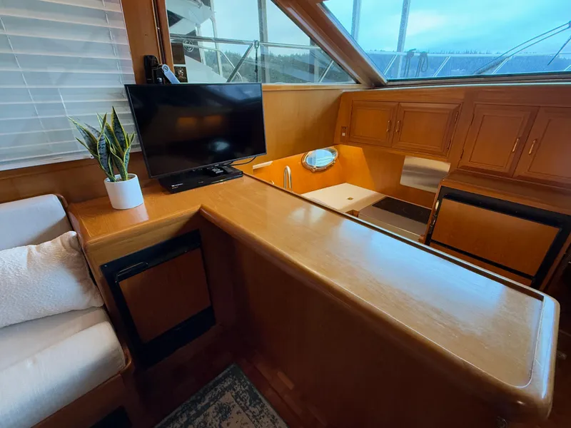 Slide: The Image of Interior of 1988 Ocean Alexander 42 CPMY yacht with TV, plant, and wooden cabinetry. - 11