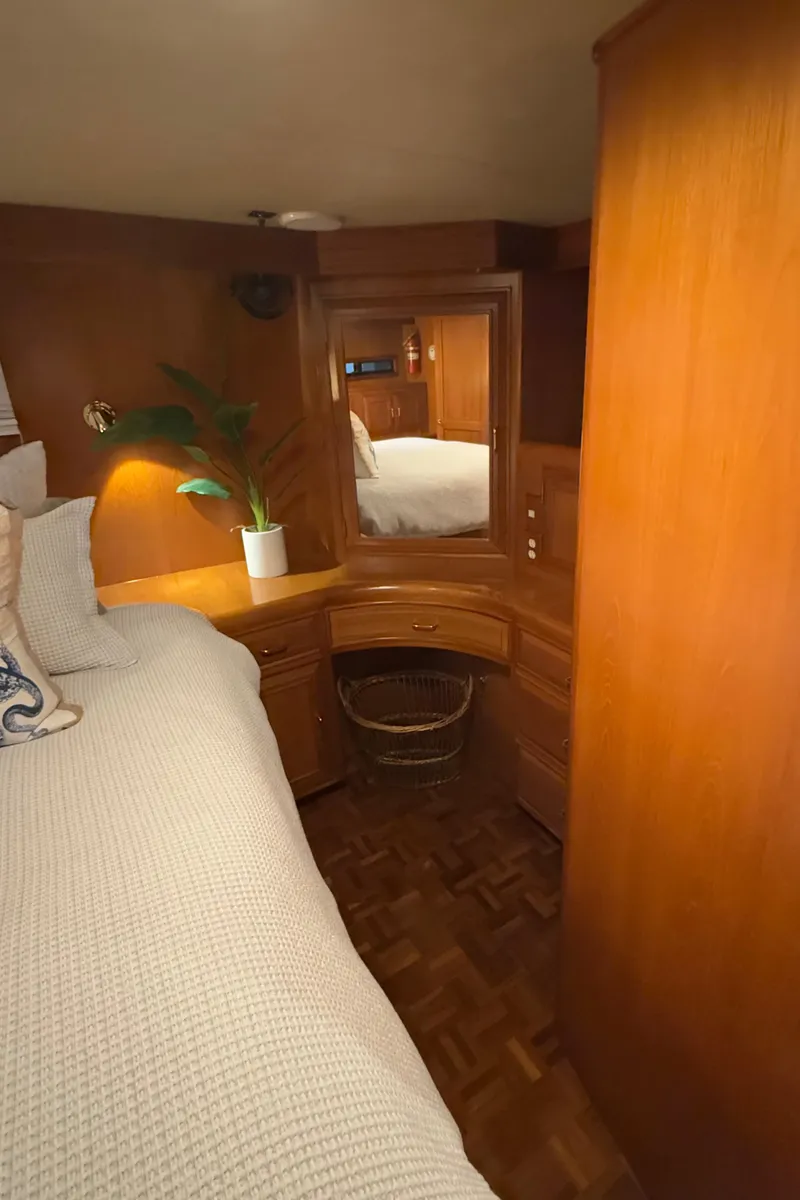 Slide: The Image of Cozy cabin interior of 1988 Ocean Alexander 42 CPMY with wood furnishings and a potted plant. - 15
