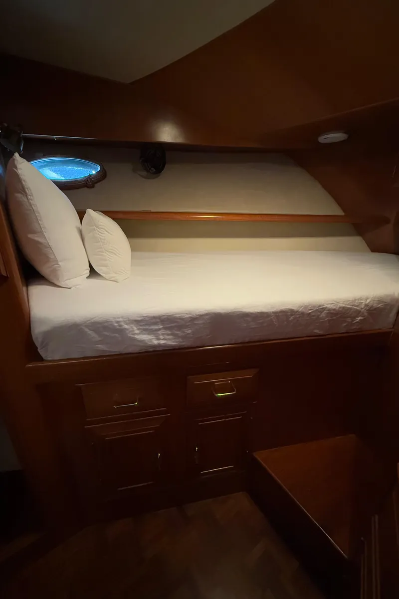 Slide: The Image of Cozy cabin interior of 1988 Ocean Alexander 42 CPMY yacht with wooden finish and porthole. - 16