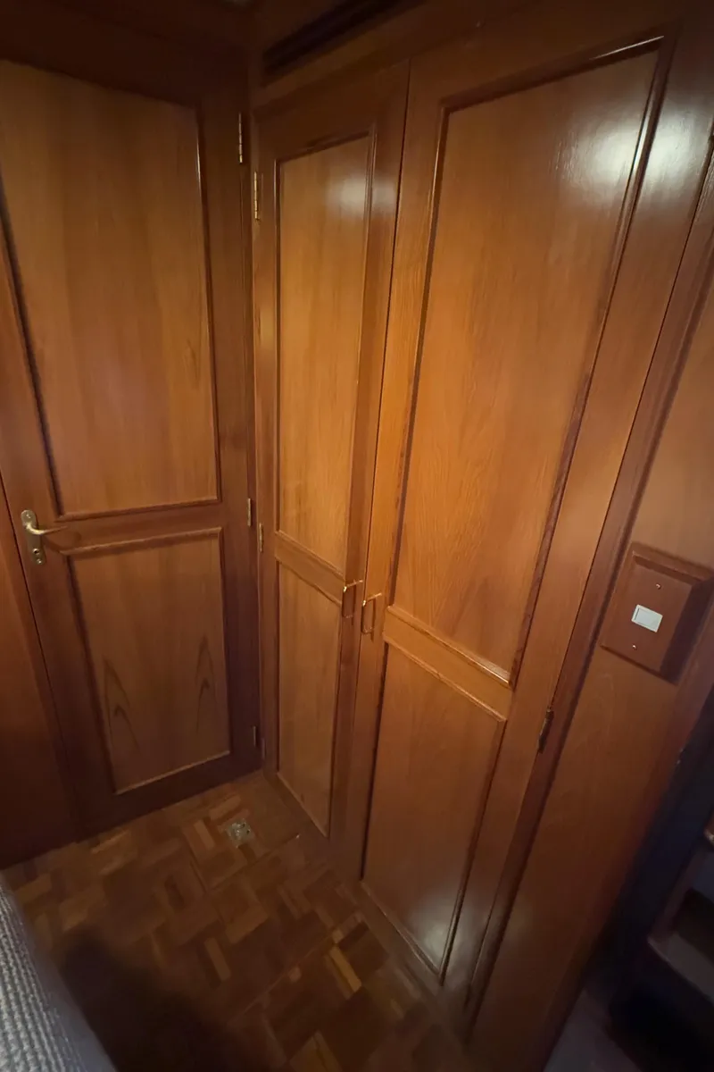 Slide: The Image of Wooden interior of 1988 Ocean Alexander 42 CPMY yacht, featuring elegant cabinetry and parquet flooring. - 18