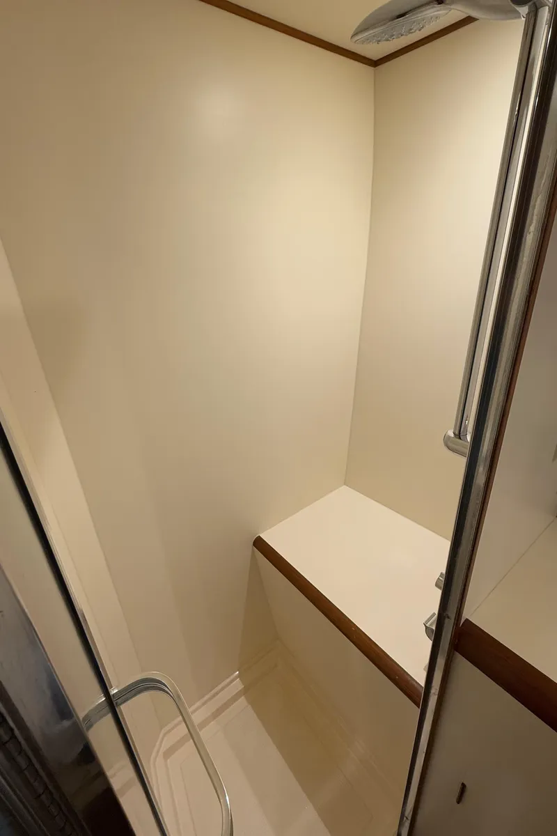 Slide: The Image of Shower area in 1988 Ocean Alexander 42 CPMY yacht, featuring minimalist design and wooden accents. - 19