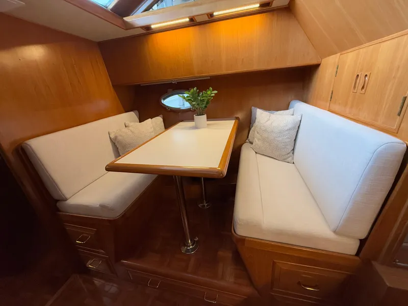 Slide: The Image of Cozy dining area in 1988 Ocean Alexander 42 CPMY yacht with wood finish and plush seating. - 20