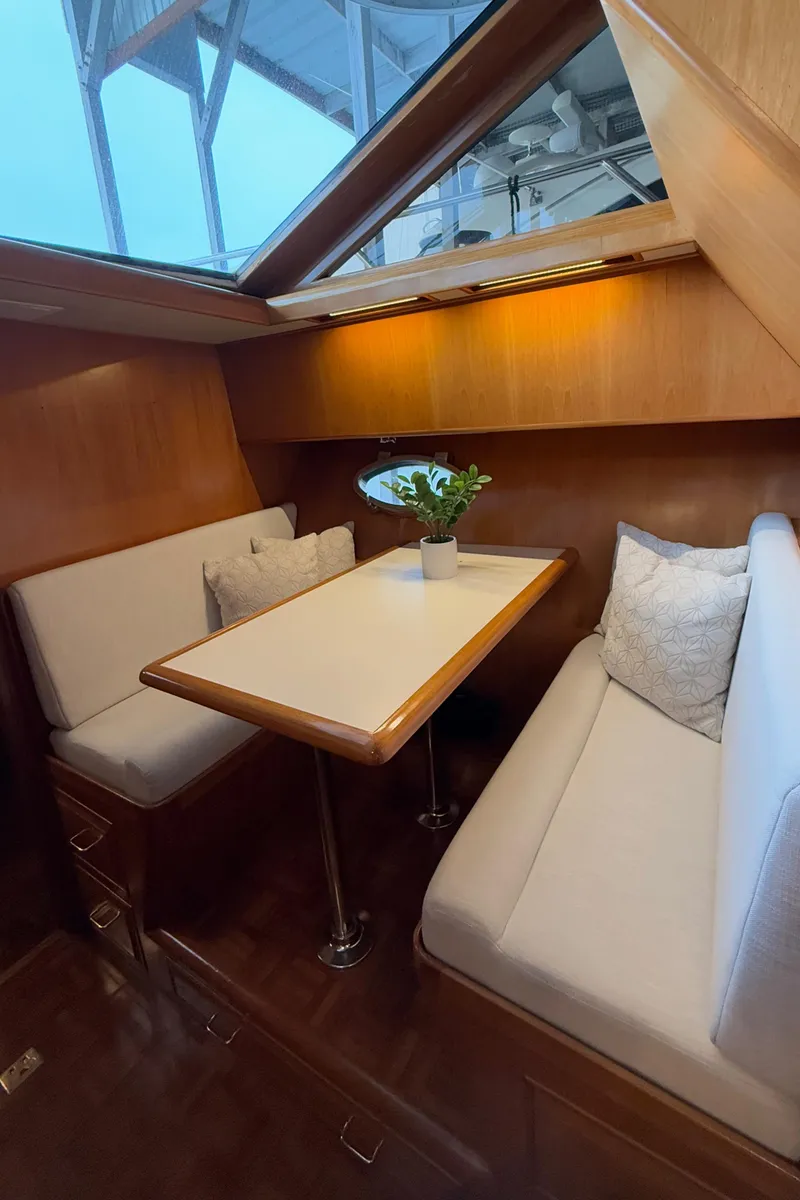 Slide: The Image of Cozy dining area in 1988 Ocean Alexander 42 CPMY yacht with skylight and plush seating. - 21
