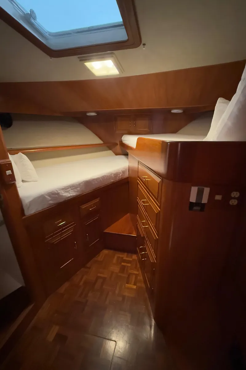 Slide: The Image of 1988 Ocean Alexander 42 CPMY cabin interior with wooden furnishings and cozy bedding. - 22