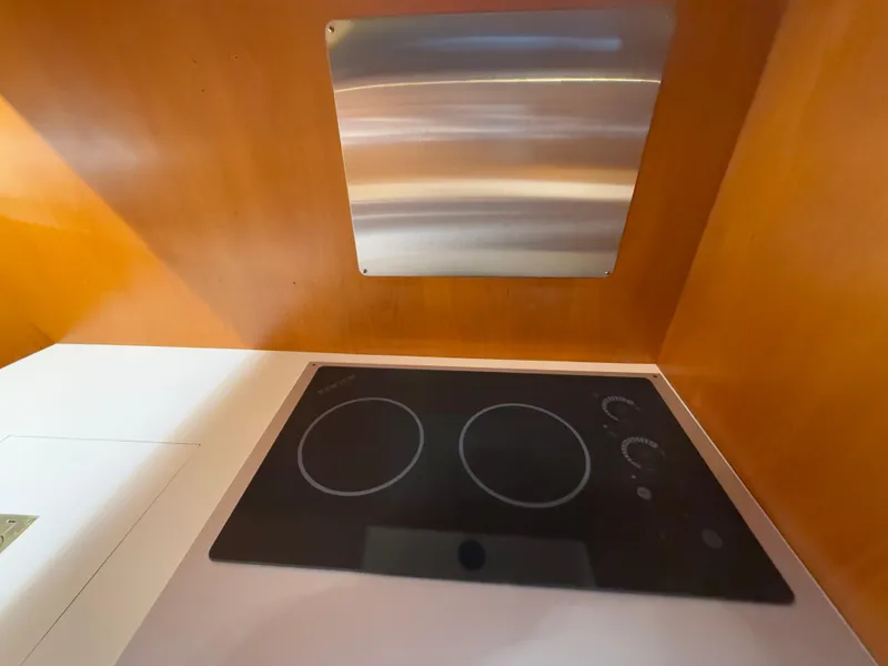 Slide: The Image of 1988 Ocean Alexander 42 CPMY kitchen with modern stovetop and wooden cabinetry. - 32