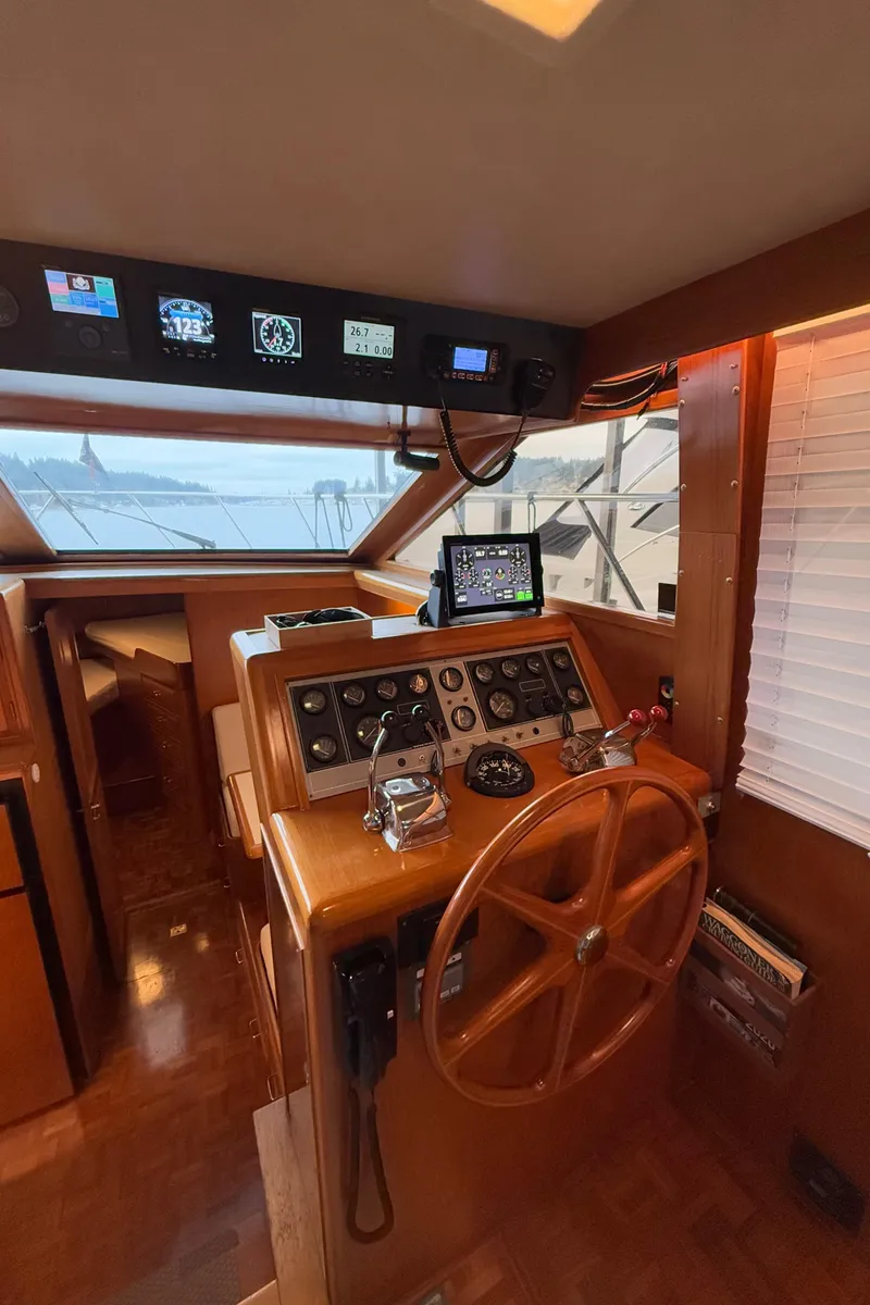 Slide: The Image of Interior helm of 1988 Ocean Alexander 42 CPMY yacht with wooden steering wheel and navigation instruments. - 34