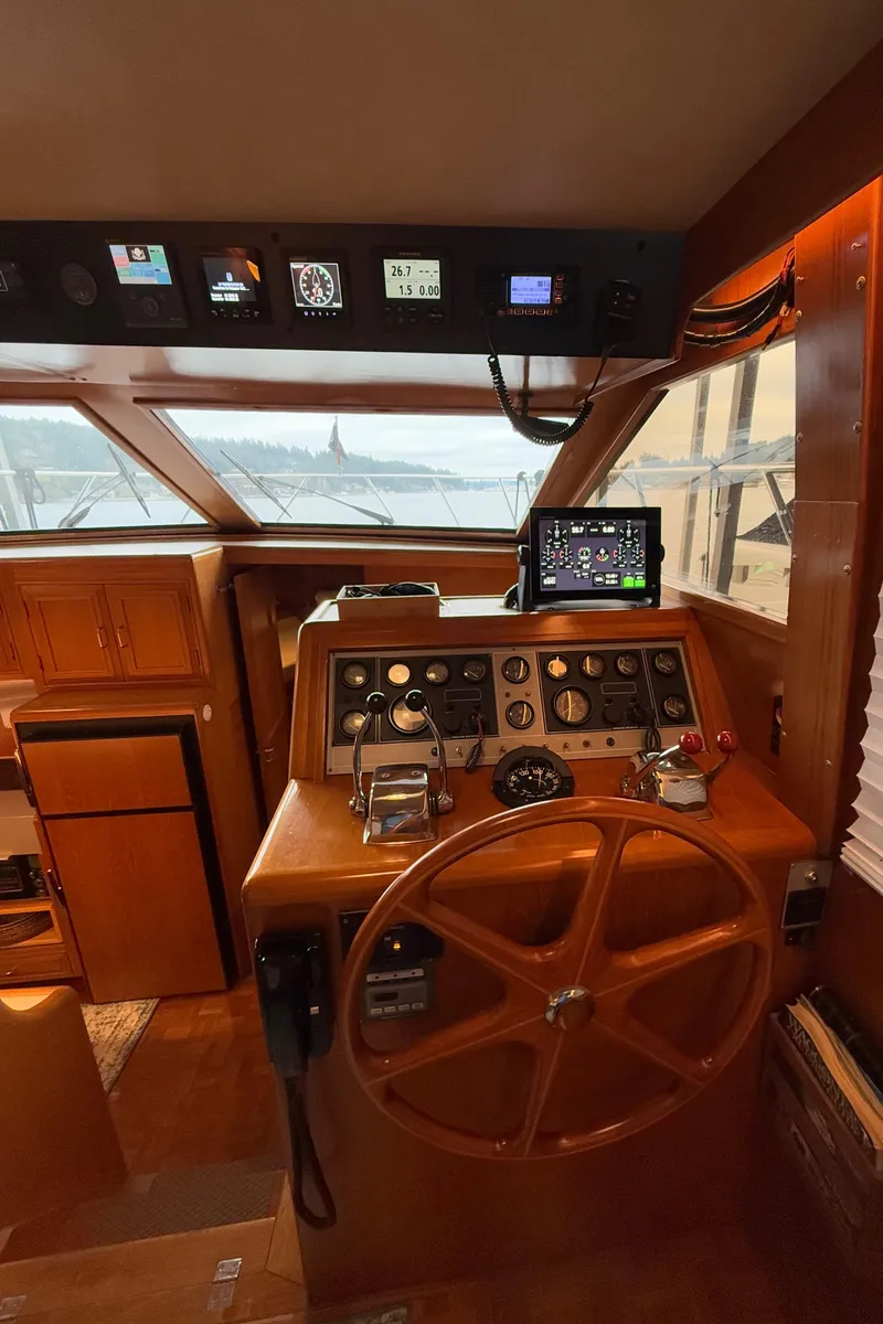Slide: The Image of 1988 Ocean Alexander 42 CPMY helm with wooden wheel and navigation instruments. - 35