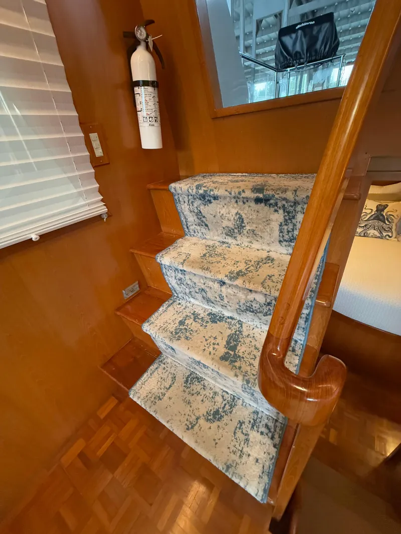 Slide: The Image of Interior stairs of 1988 Ocean Alexander 42 CPMY with patterned carpet and wooden finish. - 38