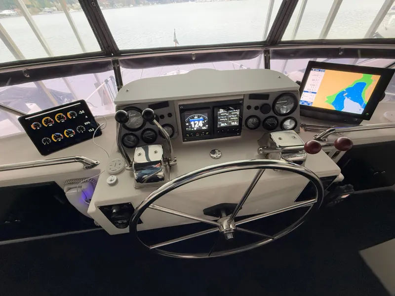 Slide: The Image of Helm of 1988 Ocean Alexander 42 CPMY with navigation instruments and steering wheel. - 42