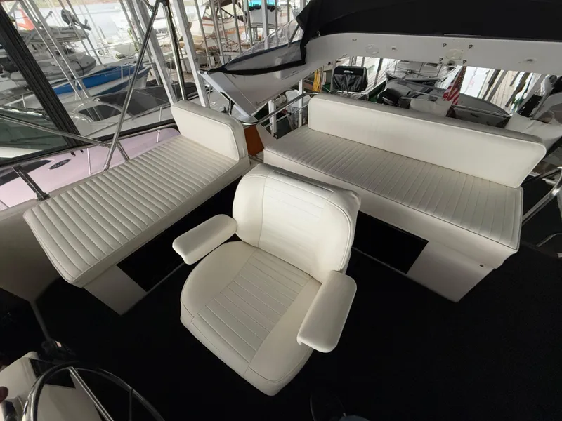 Slide: The Image of 1988 Ocean Alexander 42 CPMY yacht interior with white seating and helm chair. - 43