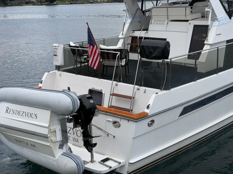 Slide: The Image of 1988 Ocean Alexander 42 CPMY yacht with American flag and dinghy, named "Rendezvous." - 46