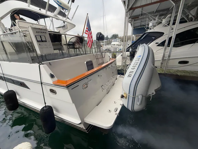 Slide: The Image of 1988 Ocean Alexander 42 CPMY yacht docked with dinghy and American flag. - 47