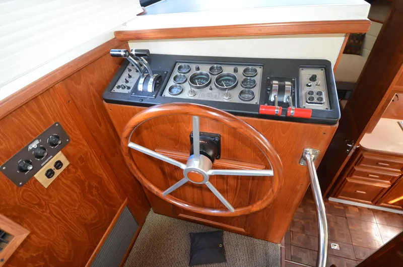 Slide: The Image of 1987 Carver 4207 helm with wooden wheel, control panel, and gauges. - 10