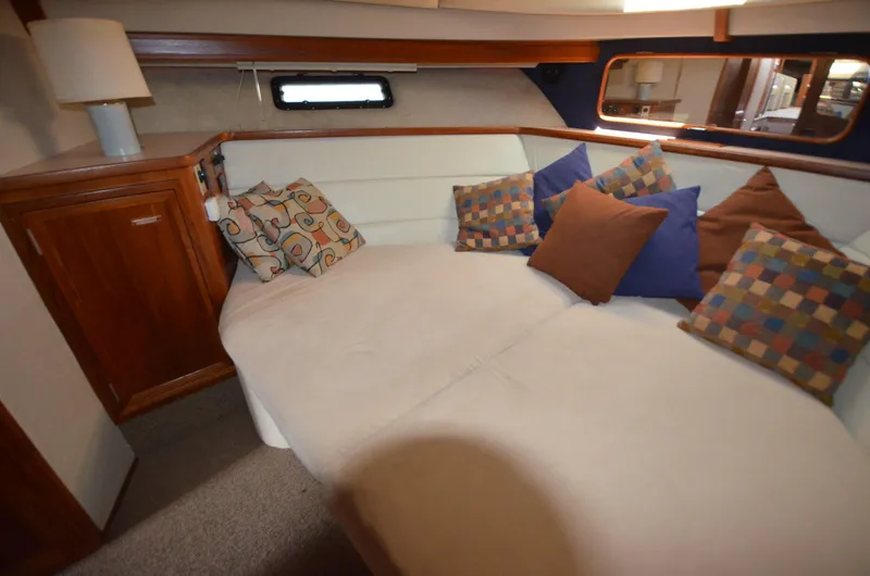 Slide: The Image of Cozy interior of 1987 Carver 4207 yacht with cushions and wooden cabinetry. - 14