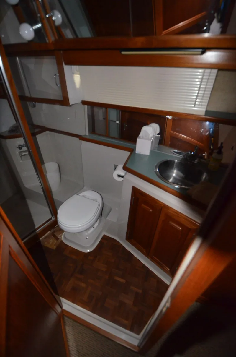 Slide: The Image of 1987 Carver 4207 yacht bathroom with wood accents, sink, and toilet. - 15