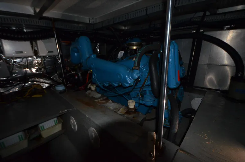 Slide: The Image of Engine room of 1987 Carver 4207 with blue machinery and metal components. - 17