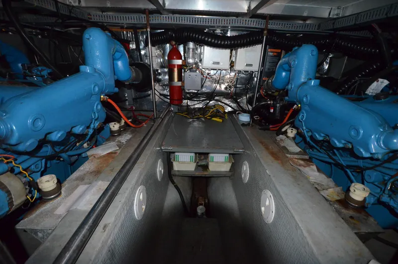 Slide: The Image of Engine room of 1987 Carver 4207 with blue engines and equipment. - 18