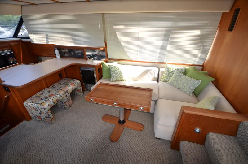 Slide: The Image of Interior of 1987 Carver 4207 yacht with cozy seating, wooden table, and modern decor. - 24