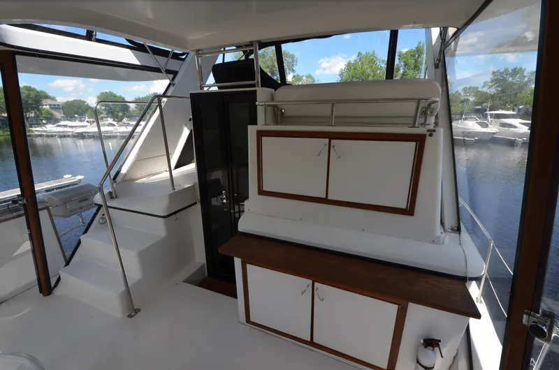 Slide: The Image of 1987 Carver 4207 yacht interior with cabinets, stairs, and marina view. - 28