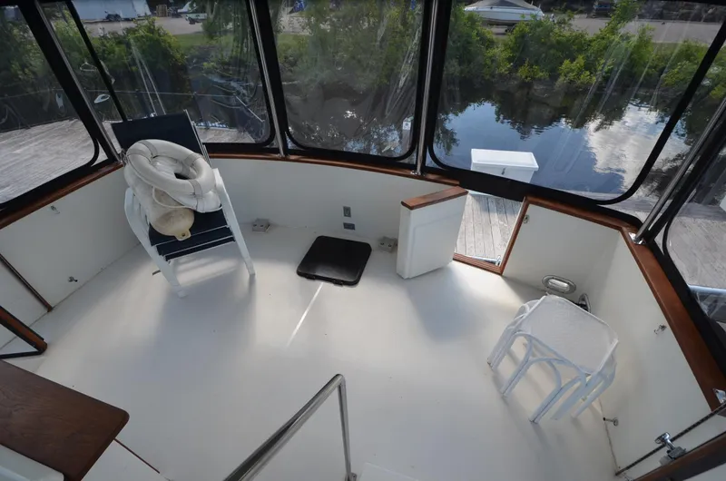 Slide: The Image of 1987 Carver 4207 boat interior with seating, windows, and water view. - 29