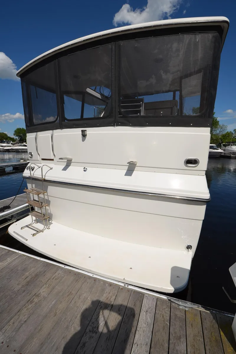 Slide: The Image of 1987 Carver 4207 yacht docked, featuring new canvas and bow thruster. - 35