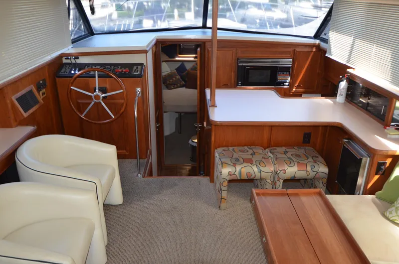 Slide: The Image of Interior of 1987 Carver 4207 yacht with helm, seating, and kitchenette. - 5