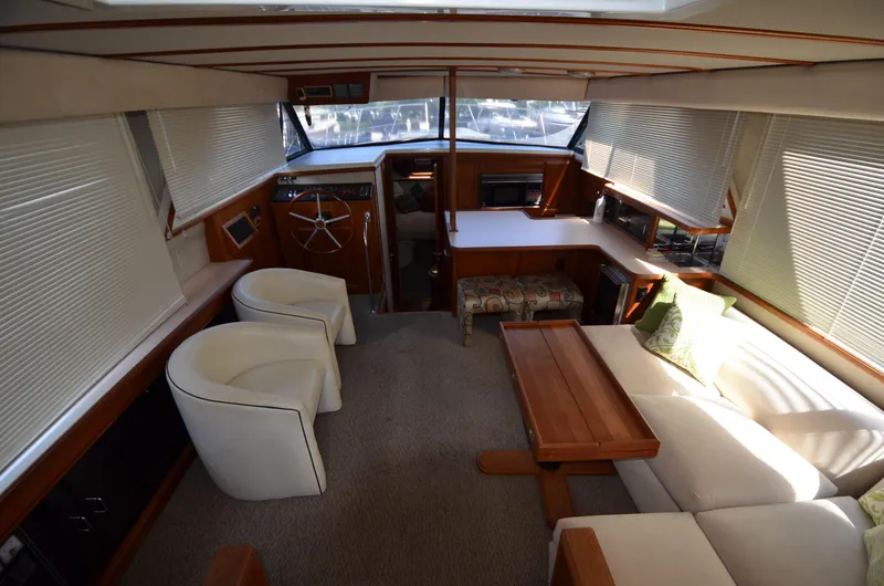 Slide: The Image of Interior of 1987 Carver 4207 yacht with modern seating and wooden accents. - 6