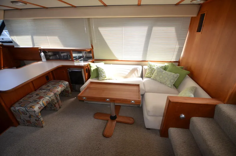 Slide: The Image of Interior of 1987 Carver 4207 yacht with cozy seating and wooden table. - 7