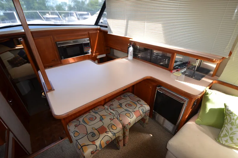 Slide: The Image of Interior of 1987 Carver 4207 yacht with modern kitchen and seating area. - 8
