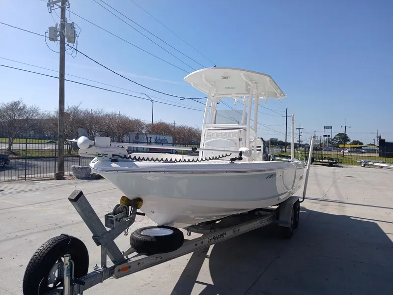 Slide: The Image of 2018 Robalo 226 Cayman boat on trailer in sunny outdoor setting. - 11
