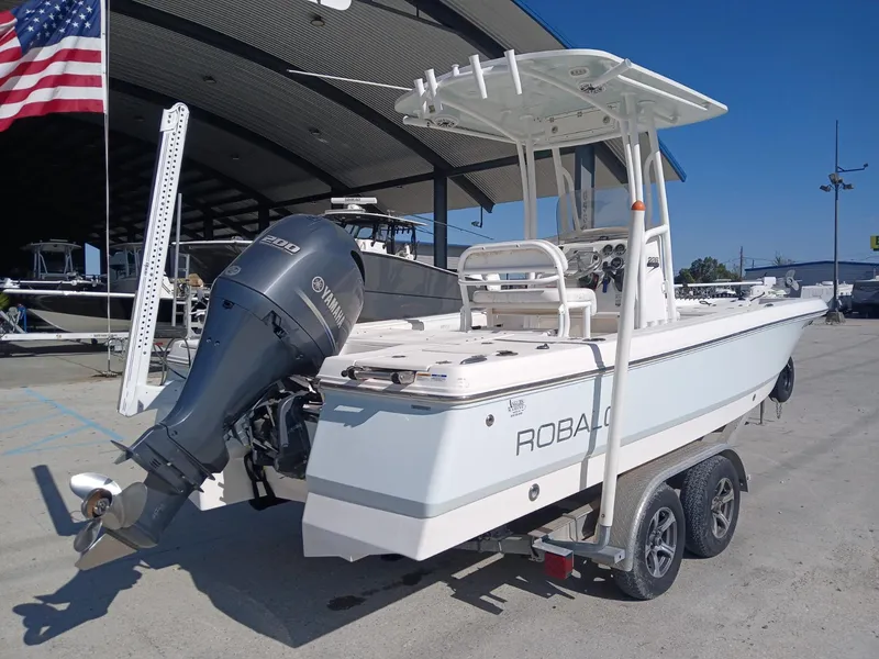 Slide: The Image of 2018 Robalo 226 Cayman boat with Yamaha engine on trailer, parked outdoors. - 9