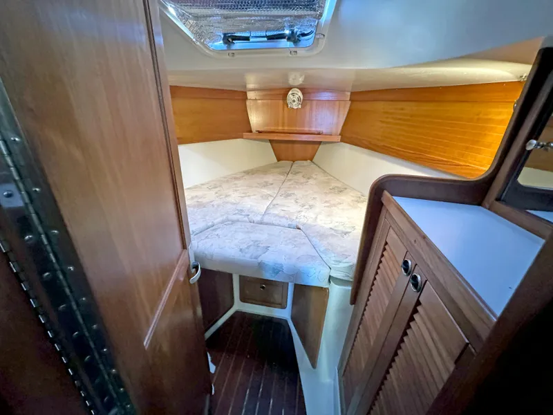 Slide: The Image of Interior cabin of 2000 Catalina 36 MkII sailboat with wood paneling and cozy bed. - 12