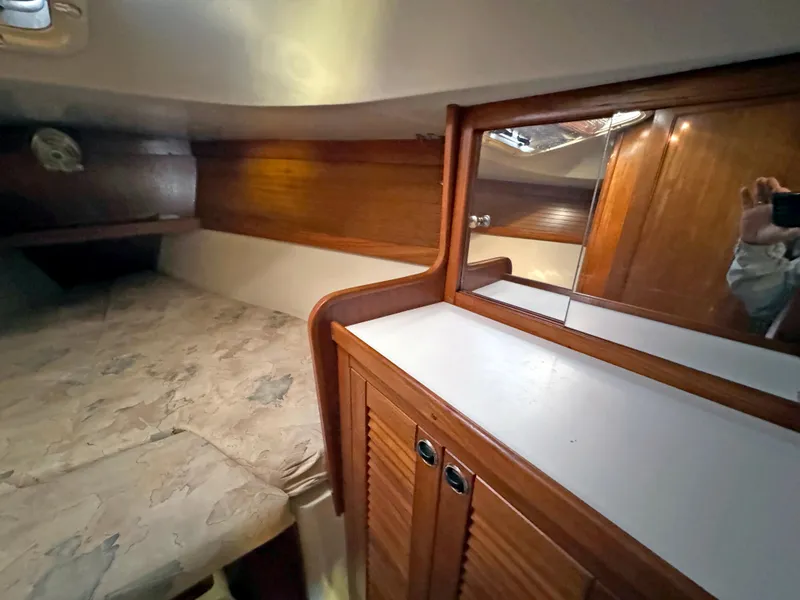 Slide: The Image of Cozy cabin interior of 2000 Catalina 36 MkII sailboat with wood accents and mirror. - 16