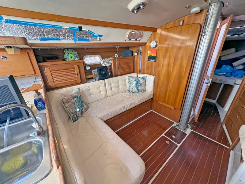 Slide: The Image of Interior of 2000 Catalina 36 MkII sailboat with cozy seating and wooden finishes. - 4