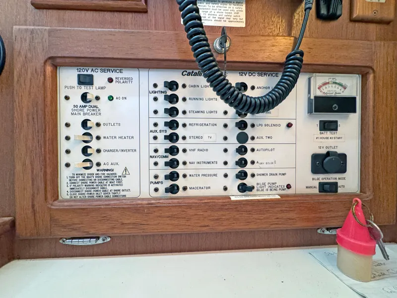 Slide: The Image of Control panel of a 2000 Catalina 36 MkII sailboat with various switches and gauges. - 6