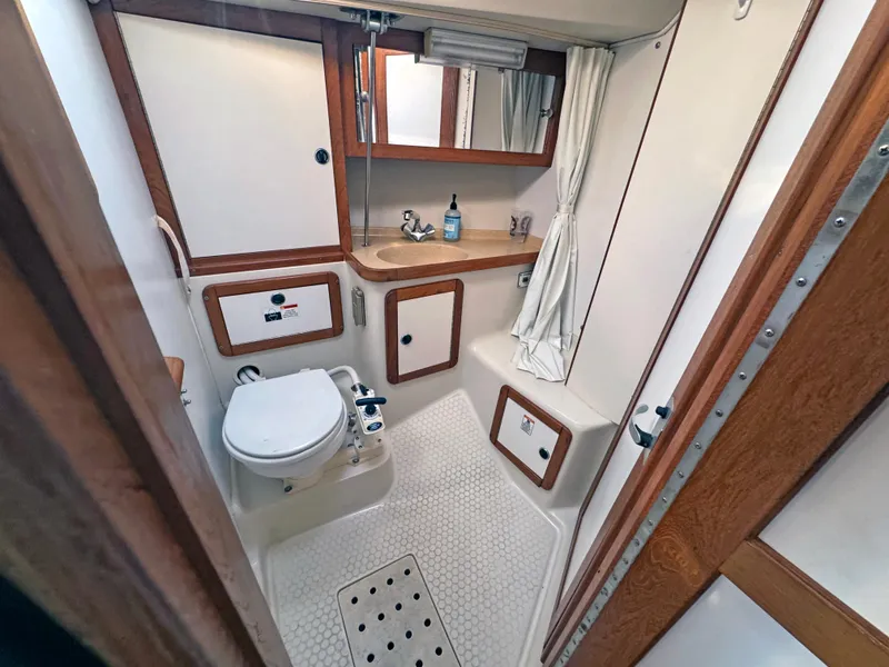 Slide: The Image of Catalina 36 MkII 2000 yacht bathroom with toilet, sink, and shower area. - 8