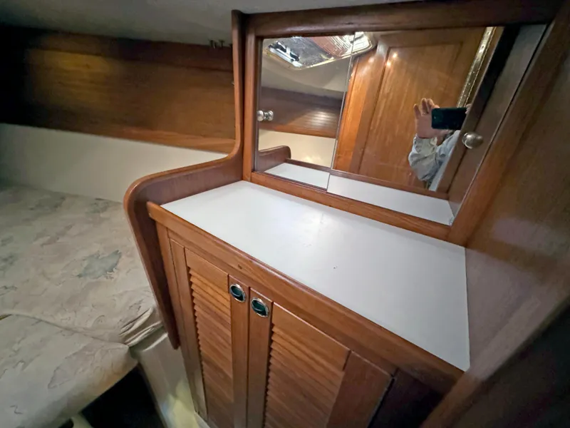 Slide: The Image of Catalina 36 MkII 2000 interior with wooden cabinetry and mirror. - 9