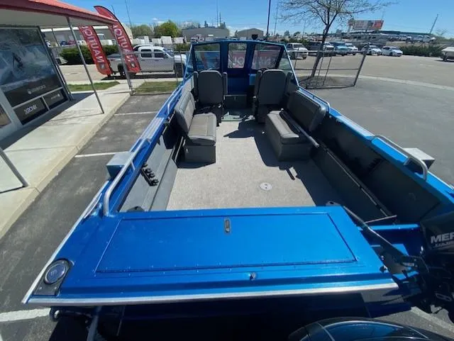 Slide: The Image of 2017 Alumaweld Intruder boat with spacious seating, parked outdoors. - 11