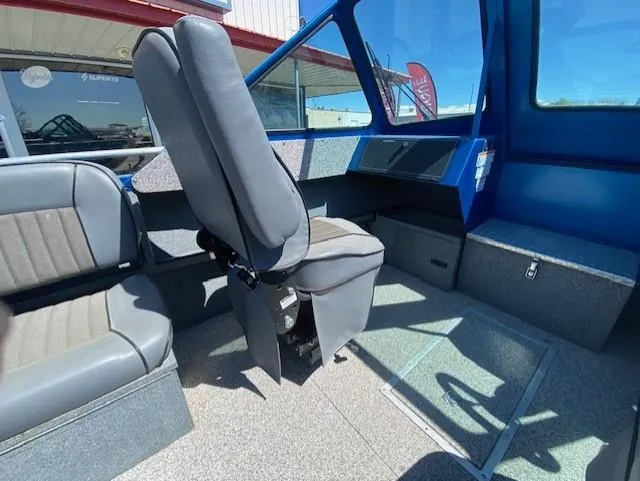 Slide: The Image of Interior of a 2017 Alumaweld Intruder boat with gray seating and blue accents. - 15