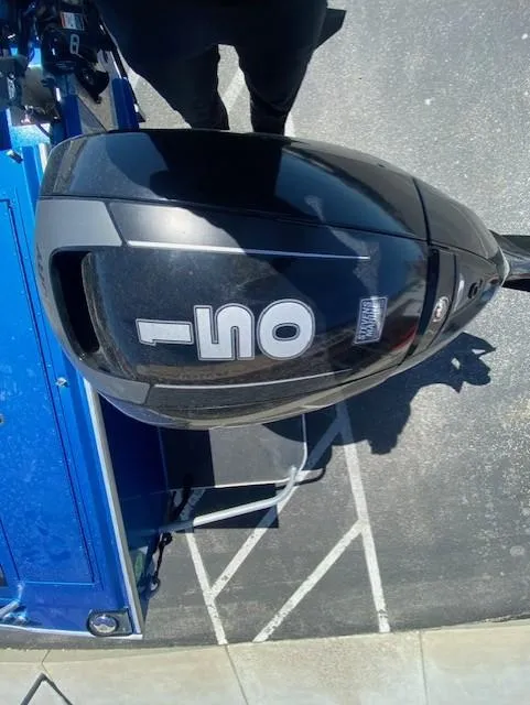 Slide: The Image of 2017 Alumaweld Intruder with black outboard motor on a blue boat. - 17