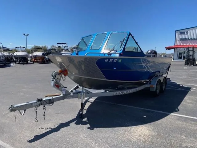 Slide: The Image of 2017 Alumaweld Intruder boat on trailer in parking lot under clear blue sky. - 8