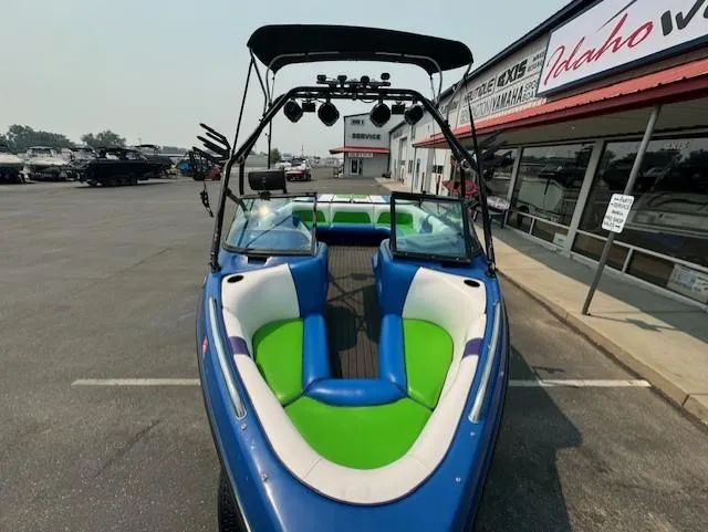 Slide: The Image of 2005 Calabria Cal Air Pro-V boat with vibrant seating, parked outside a dealership. - 10