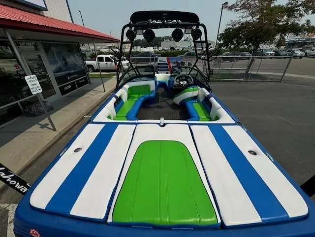 Slide: The Image of 2005 Calabria Cal Air Pro-V boat with blue, white, and green interior, parked outdoors. - 11