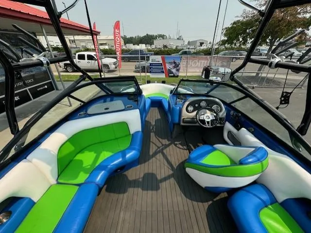 Slide: The Image of 2005 Calabria Cal Air Pro-V boat interior with vibrant green and blue seating. - 12