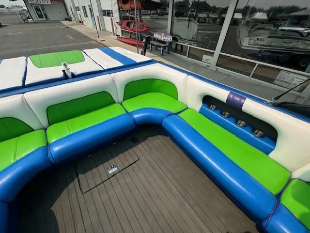 Slide: The Image of 2005 Calabria Cal Air Pro-V boat interior with blue and green seating. - 16