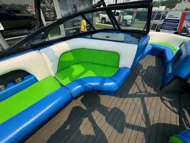 Slide: The Image of 2005 Calabria Cal Air Pro-V boat interior with vibrant green and blue seating. - 17